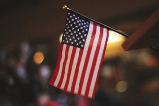 An American flag with a blurred background